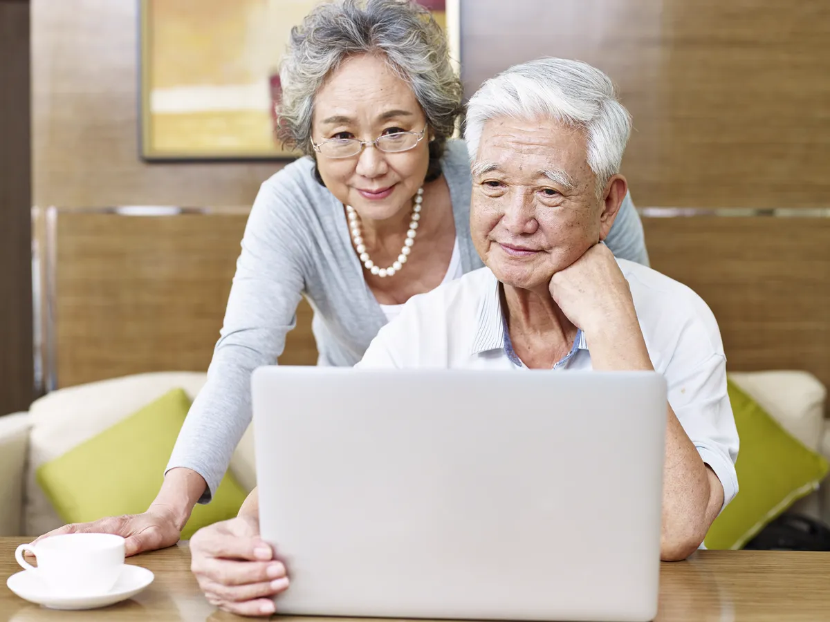 Senior Asian couple browsing confidently together