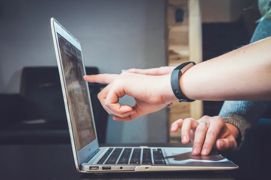 A customer confidently using a laptop at home